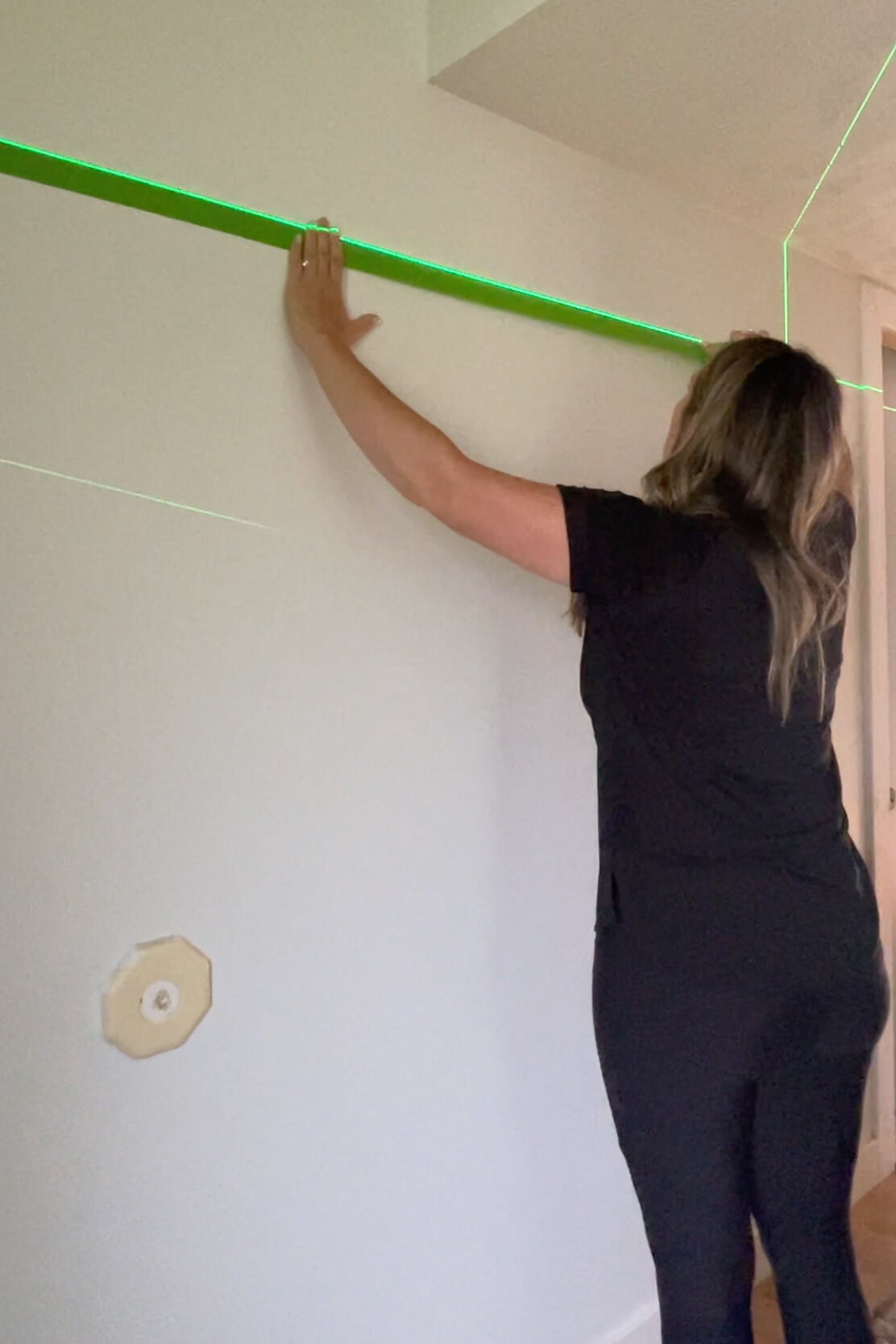 Using painters tape to plan a gallery wall layout.